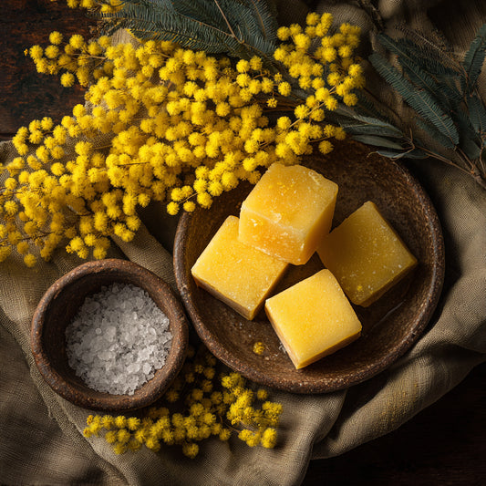 Mimosa floral wax — a golden, aromatic wax with warm, powdery floral notes. Nourishes skin and enriches balms, perfumes, and luxury skincare.